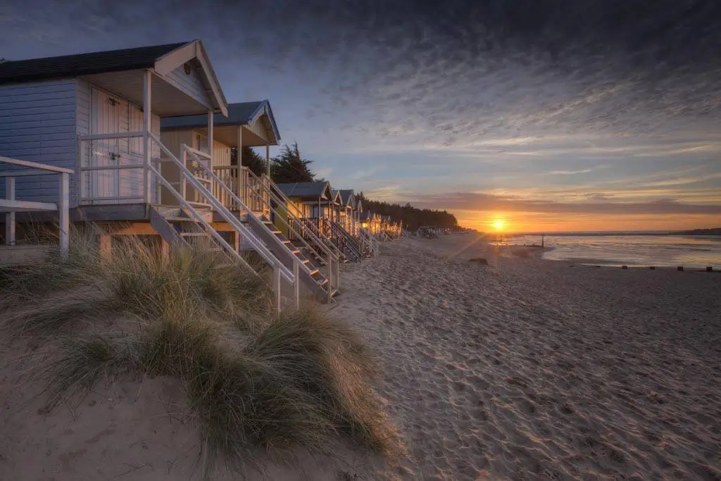 beach huts at sunset