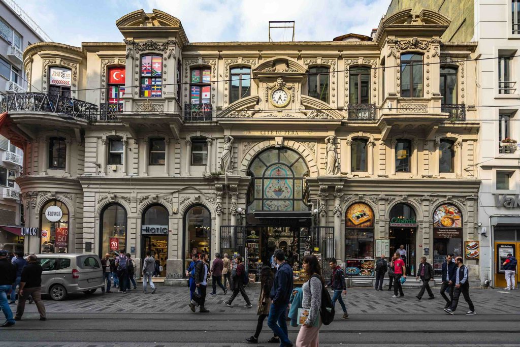 People walk in front of Cite de Pera, or Çiçek Pasajı (Flower Passage), in Beyoğlu, Istanbul, Turkey, October 2018. (Shutterstock Photo)